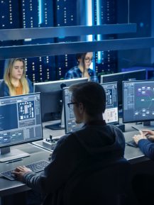 Team of IT Programers Working on Desktop Computers in Data Center System Control Room. Team of Young Professionals Working In Software and Hardware Development, Doing Coding