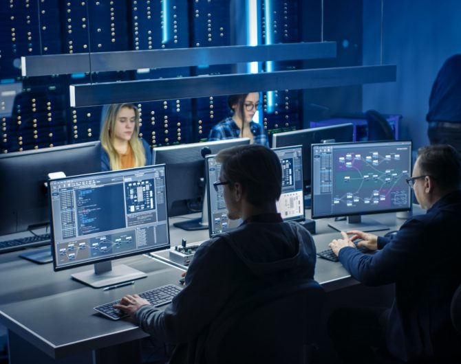 Team of IT Programers Working on Desktop Computers in Data Center System Control Room. Team of Young Professionals Working In Software and Hardware Development, Doing Coding